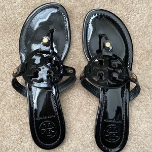 Authentic- Tory Burch Miller Sandal in black patent leather.